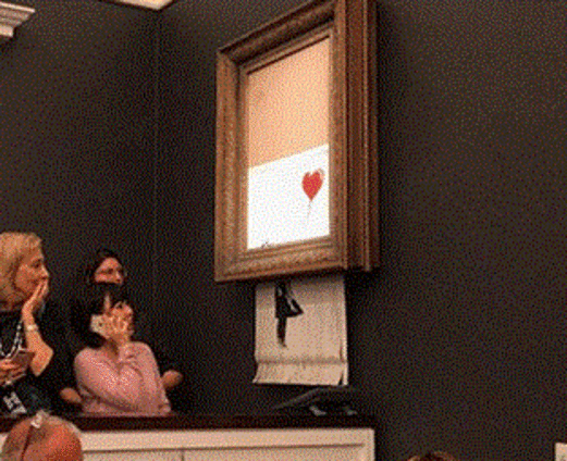 لوحة للفنان بانكسي تمزق نفسها فور بيعها في مزاد لوحة للفنان بانكسي تمزق نفسها فور بيعها في مزاد